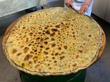 Fresh-baked Soparnik pie is coated with Dalmatian olive oil and sprinkled with raw garlic, then it’s ready to be sliced into the familiar diamond-shaped pieces and served. A pie yields about 40 slices.